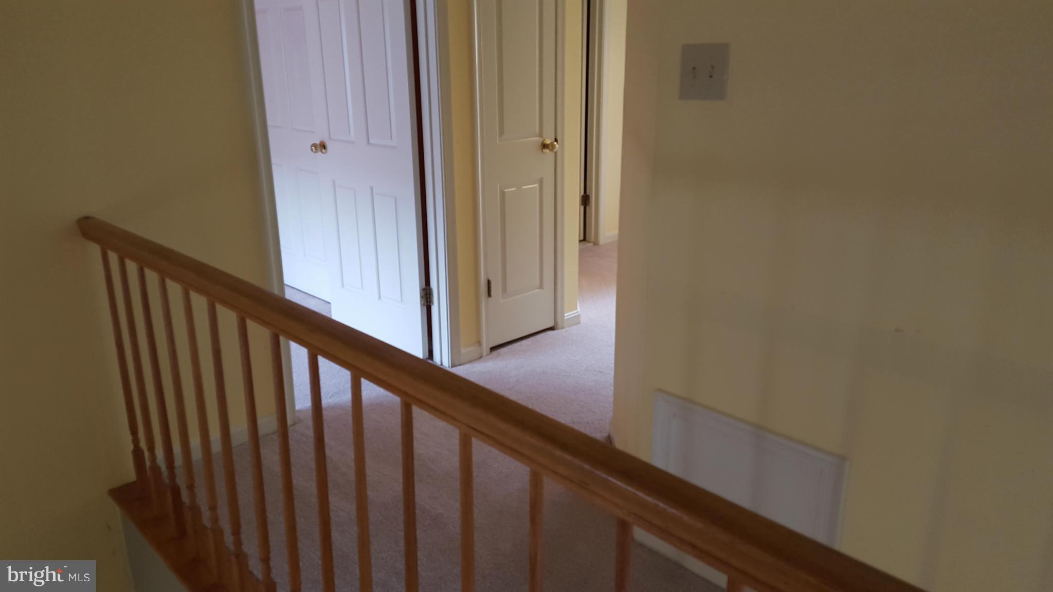 5117 Columbia Road, Unit 1427 Columbia, MD 21044 - Photo 10 of 30 Wide staircase leads to upstairs hallway