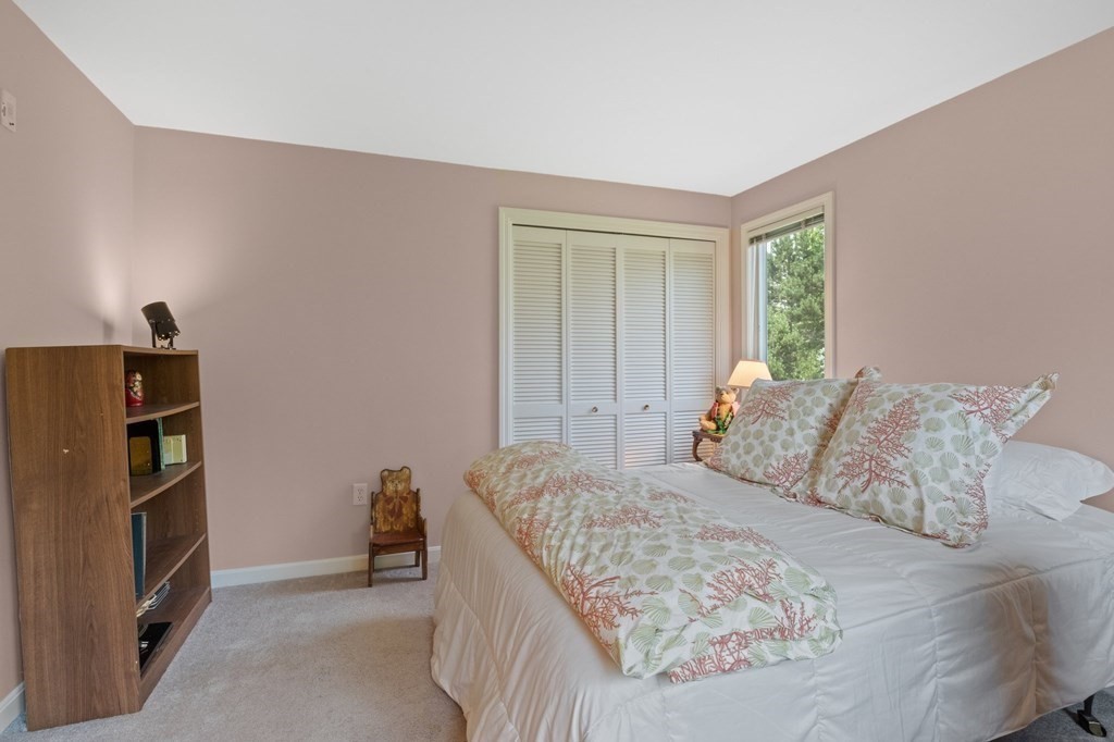 5 Woods Edge Lane, Unit 5 Mashpee, MA 02649 - Photo 12 of 29 a bedroom with a bed and a refrigerator