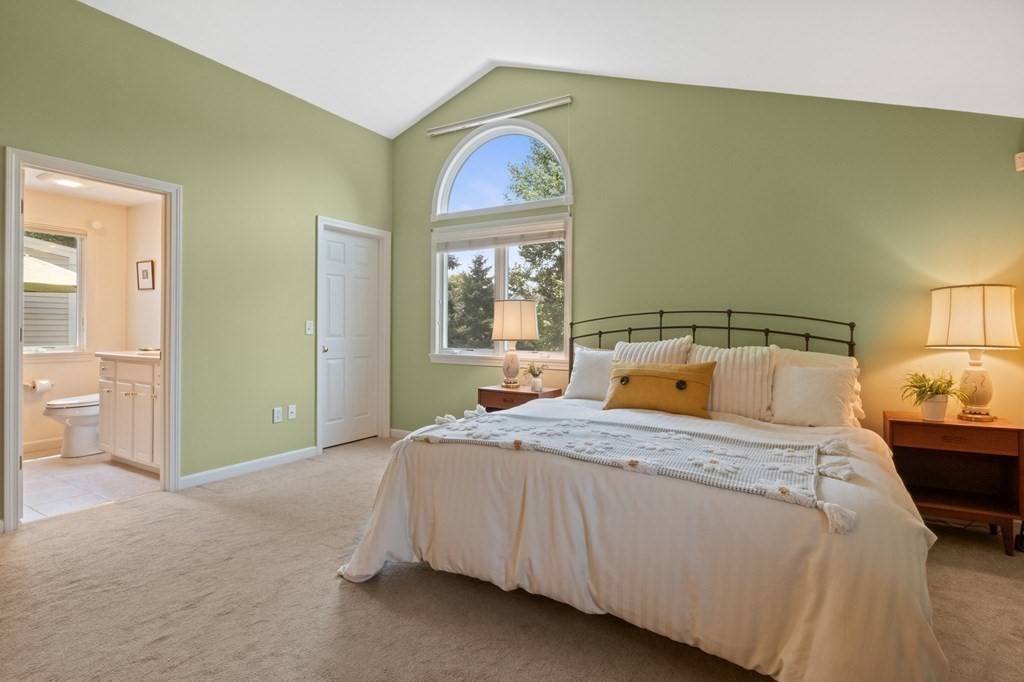 5 Woods Edge Lane, Unit 5 Mashpee, MA 02649 - Photo 15 of 29 a bedroom with a bed and a painting on the wall
