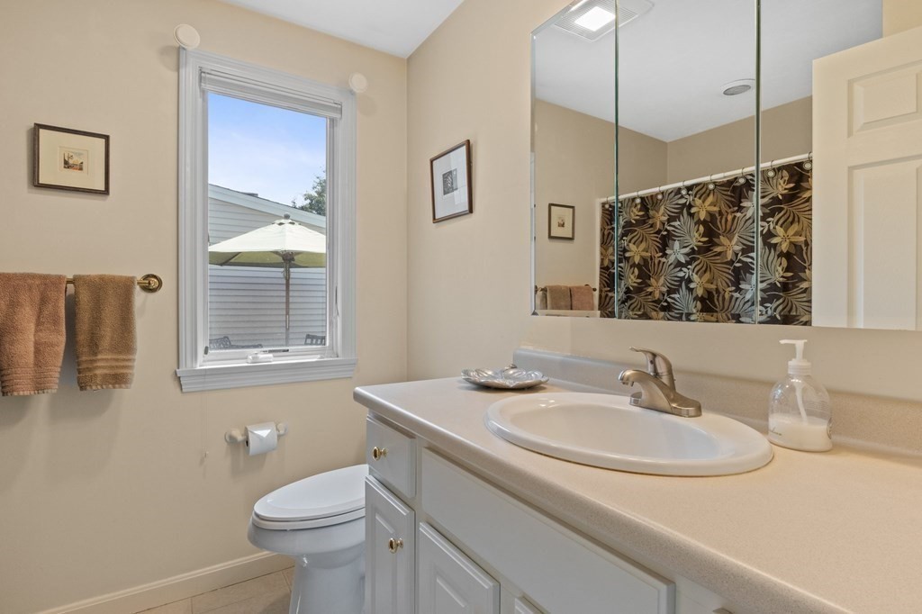 5 Woods Edge Lane, Unit 5 Mashpee, MA 02649 - Photo 16 of 29 a bathroom with a sink toilet and a mirror