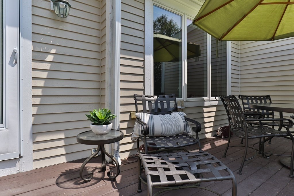 5 Woods Edge Lane, Unit 5 Mashpee, MA 02649 - Photo 17 of 29 a table and chairs in a patio
