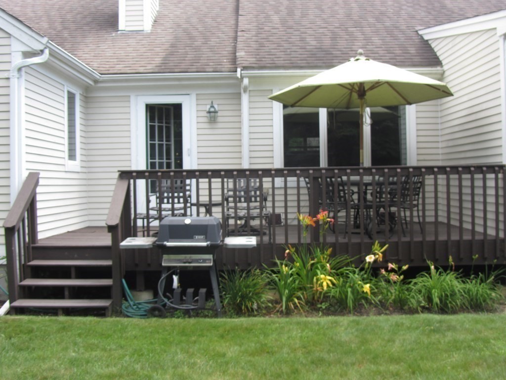 5 Woods Edge Lane, Unit 5 Mashpee, MA 02649 - Photo 18 of 29 a view of a house with backyard and sitting area