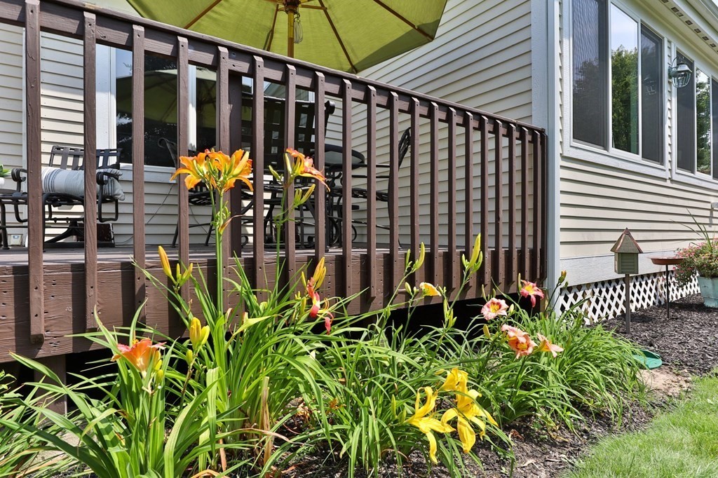5 Woods Edge Lane, Unit 5 Mashpee, MA 02649 - Photo 19 of 29 a view of a house with a flower garden