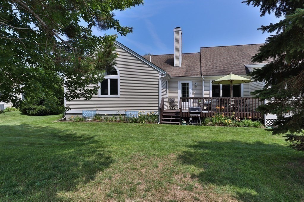 5 Woods Edge Lane, Unit 5 Mashpee, MA 02649 - Photo 20 of 29 a front view of house with yard and green space