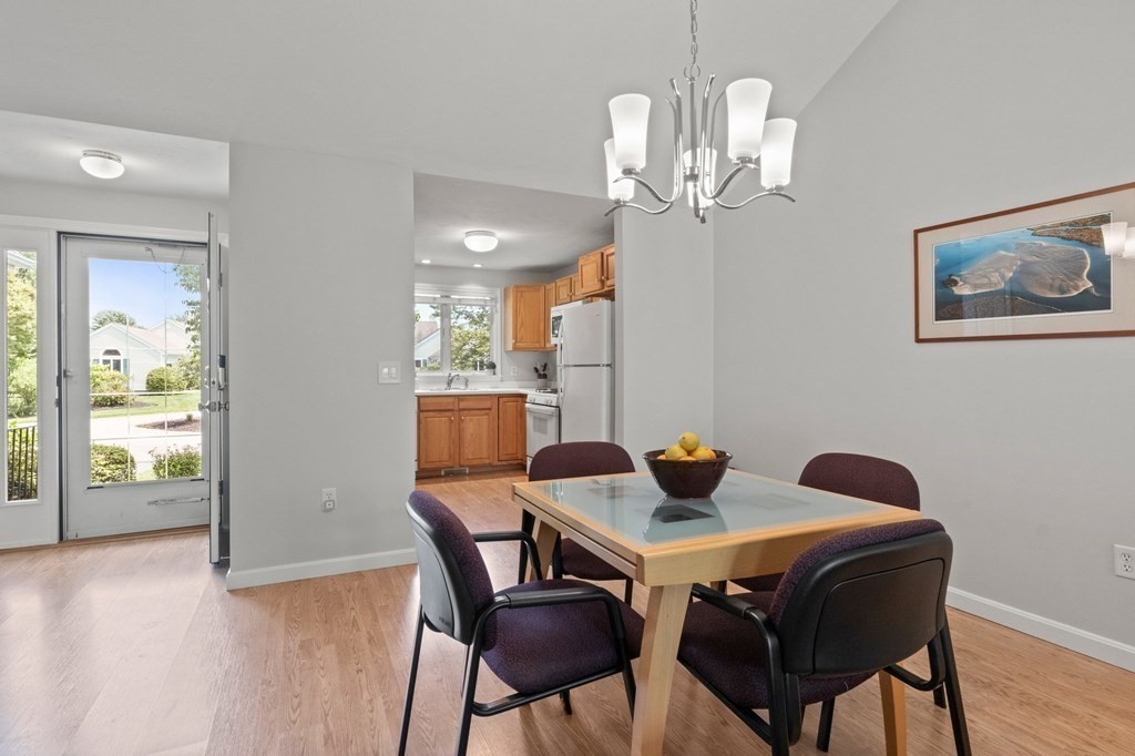 5 Woods Edge Lane, Unit 5 Mashpee, MA 02649 - Photo 4 of 29 a view of a dining room with furniture and wooden floor