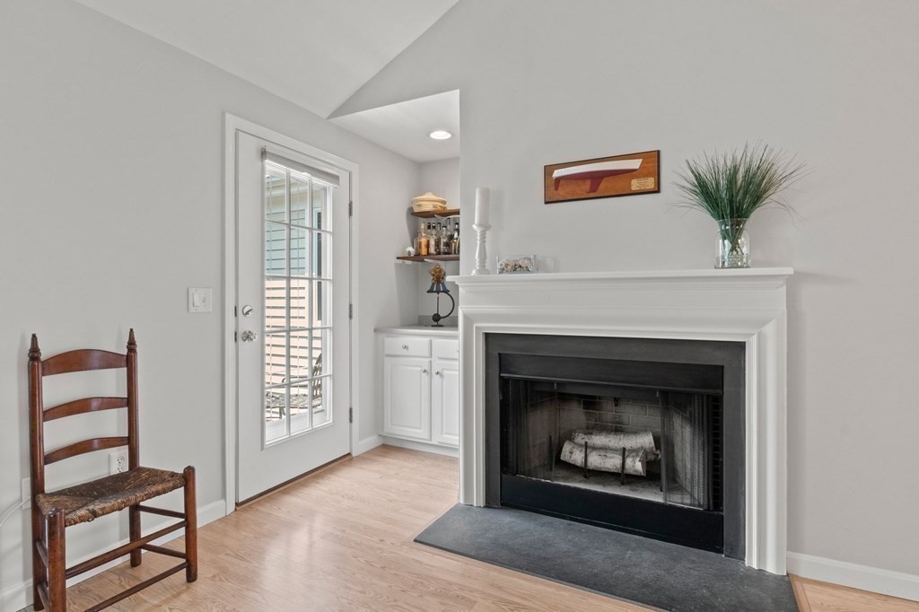5 Woods Edge Lane, Unit 5 Mashpee, MA 02649 - Photo 9 of 29 a living room with furniture a fireplace and a window