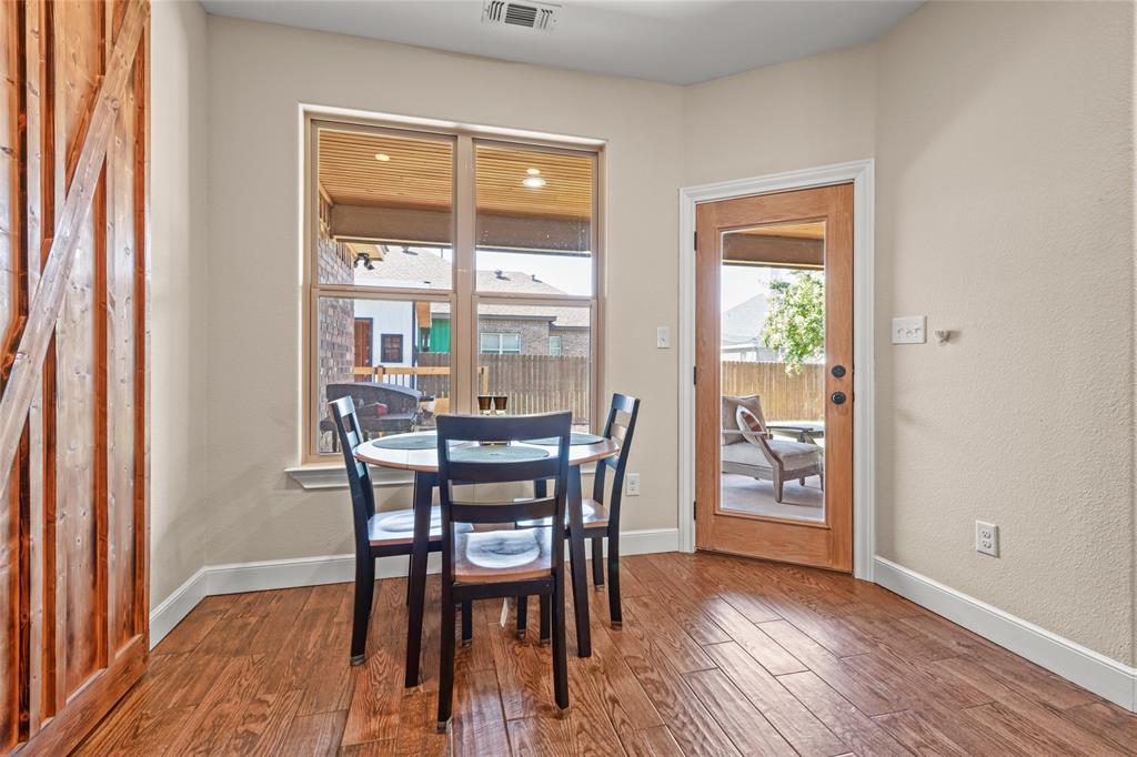 3801 Kady Ridge Abilene, TX 79606 - Photo 18 of 40 Wood-finish flooring, a full-lite exterior door, and a large window