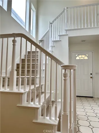 a view of staircase with white walls and windows