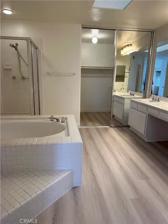 a bathroom with a tub sink and mirror
