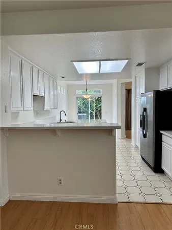 a kitchen with stainless steel appliances a refrigerator a sink a stove a microwave and cabinets