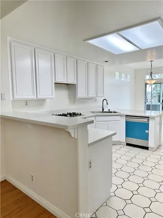 a kitchen with stainless steel appliances a sink and a stove