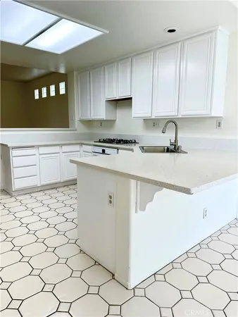 a kitchen with a sink a stove and cabinets
