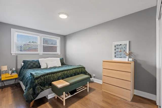 a bedroom with a bed and a dresser