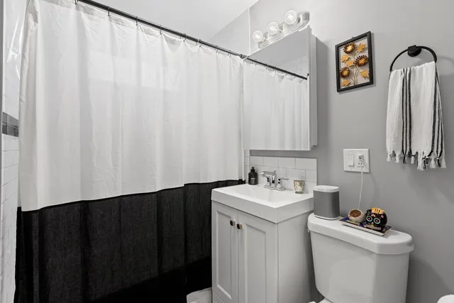 a bathroom with a sink toilet and vanity
