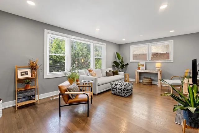 a living room with furniture and wooden floor