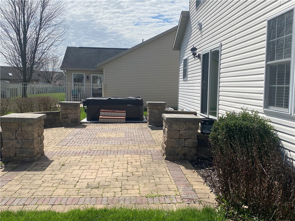 541 North Point Troy, OH 45373 - Photo 21 of 23 This inviting patio area features a relaxing spa and durable brick pavers, perfect for outdoor enjoyment.