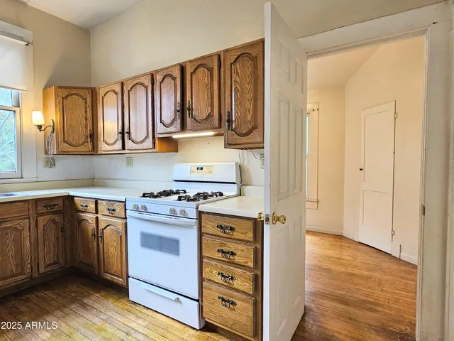 a kitchen with stainless steel appliances granite countertop a stove and a refrigerator