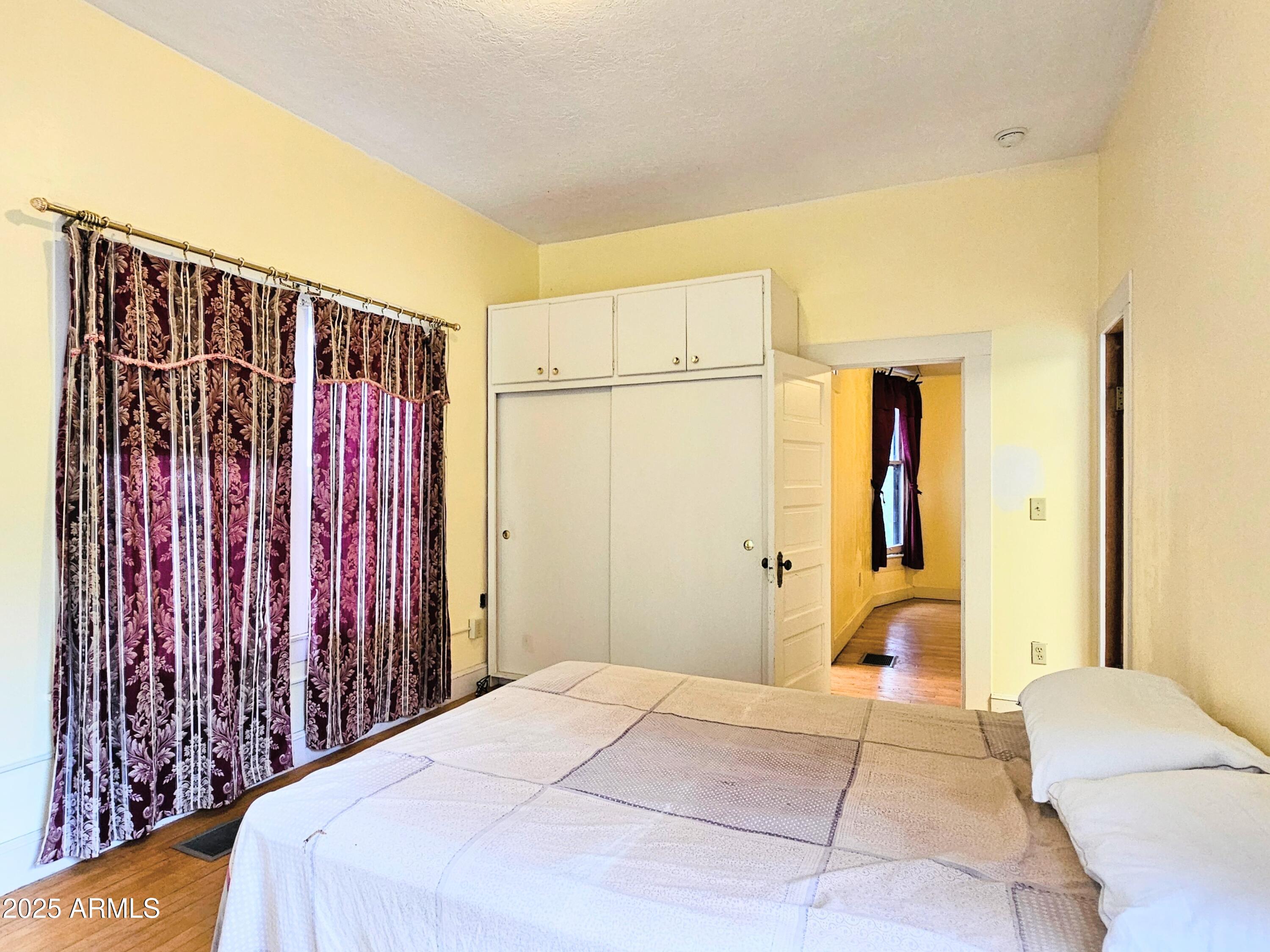 164 Quality Hill Road Bisbee, AZ 85603 - Photo 17 of 36 a bedroom with a bed and a closet