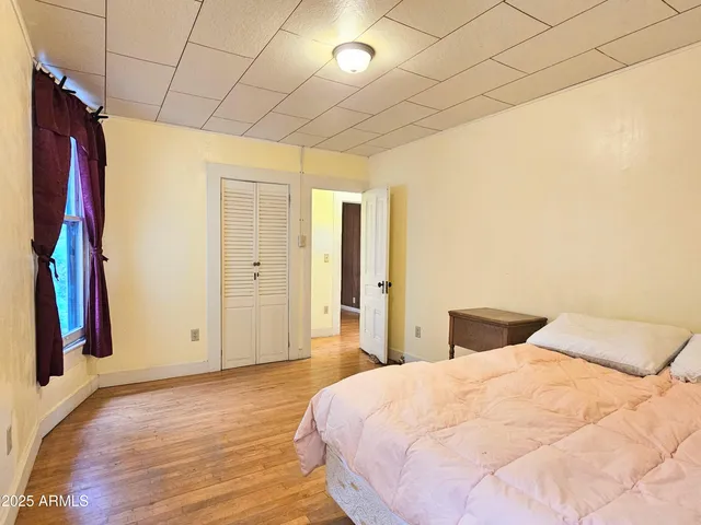 a bedroom with a bed and a window