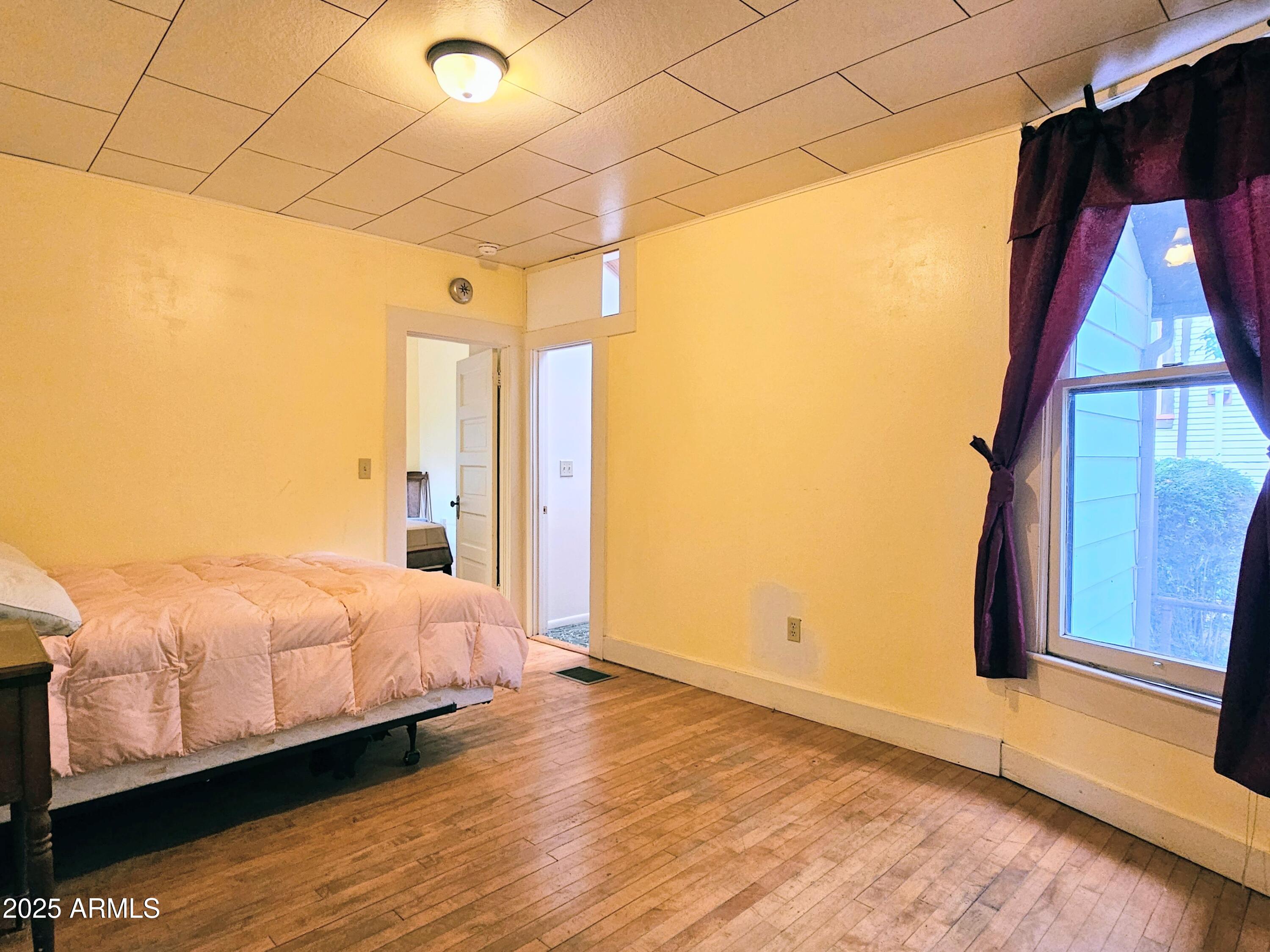 164 Quality Hill Road Bisbee, AZ 85603 - Photo 20 of 36 a bedroom with a bed and a window