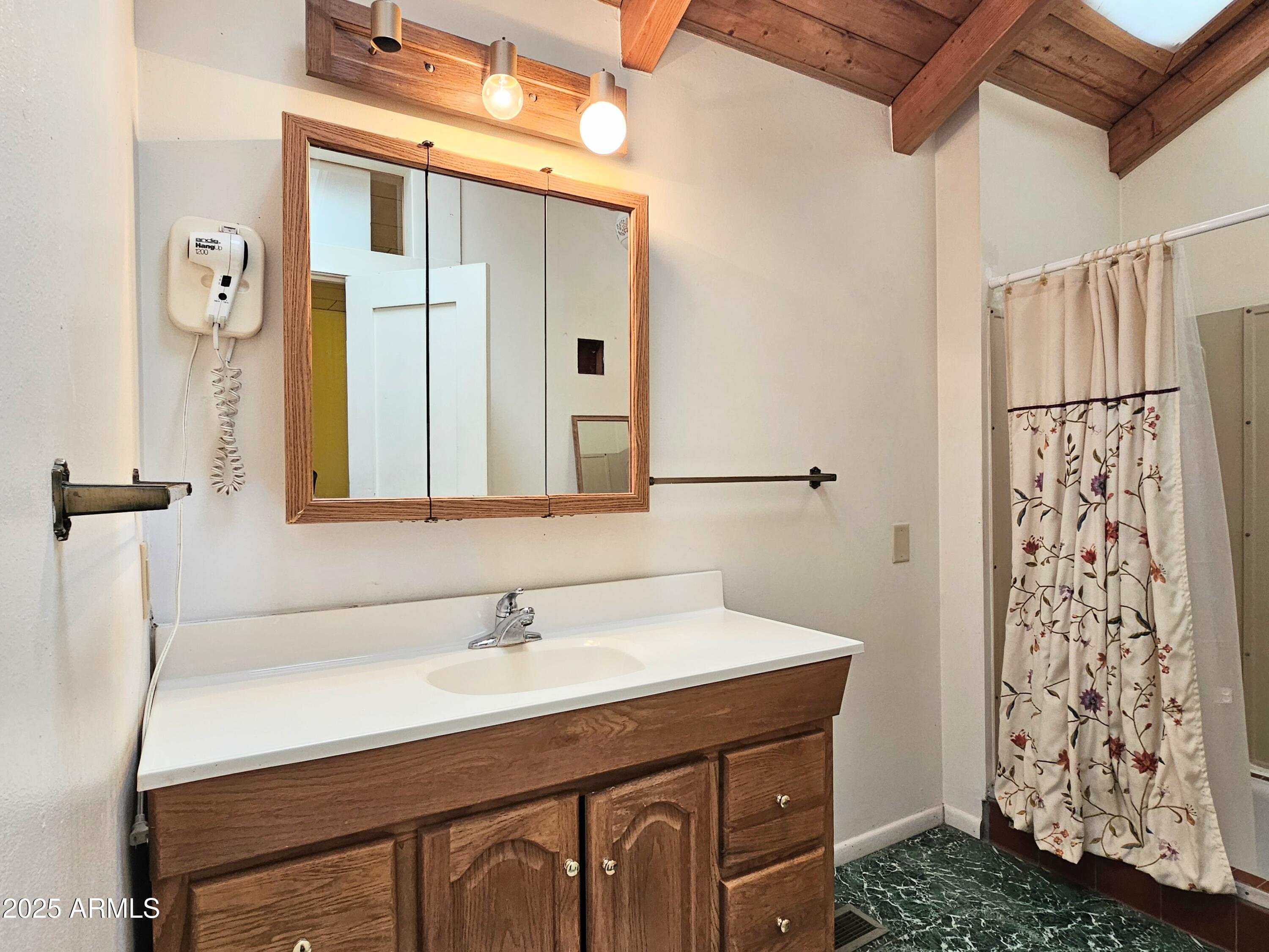 164 Quality Hill Road Bisbee, AZ 85603 - Photo 22 of 36 a bathroom with a sink vanity granite and a mirror