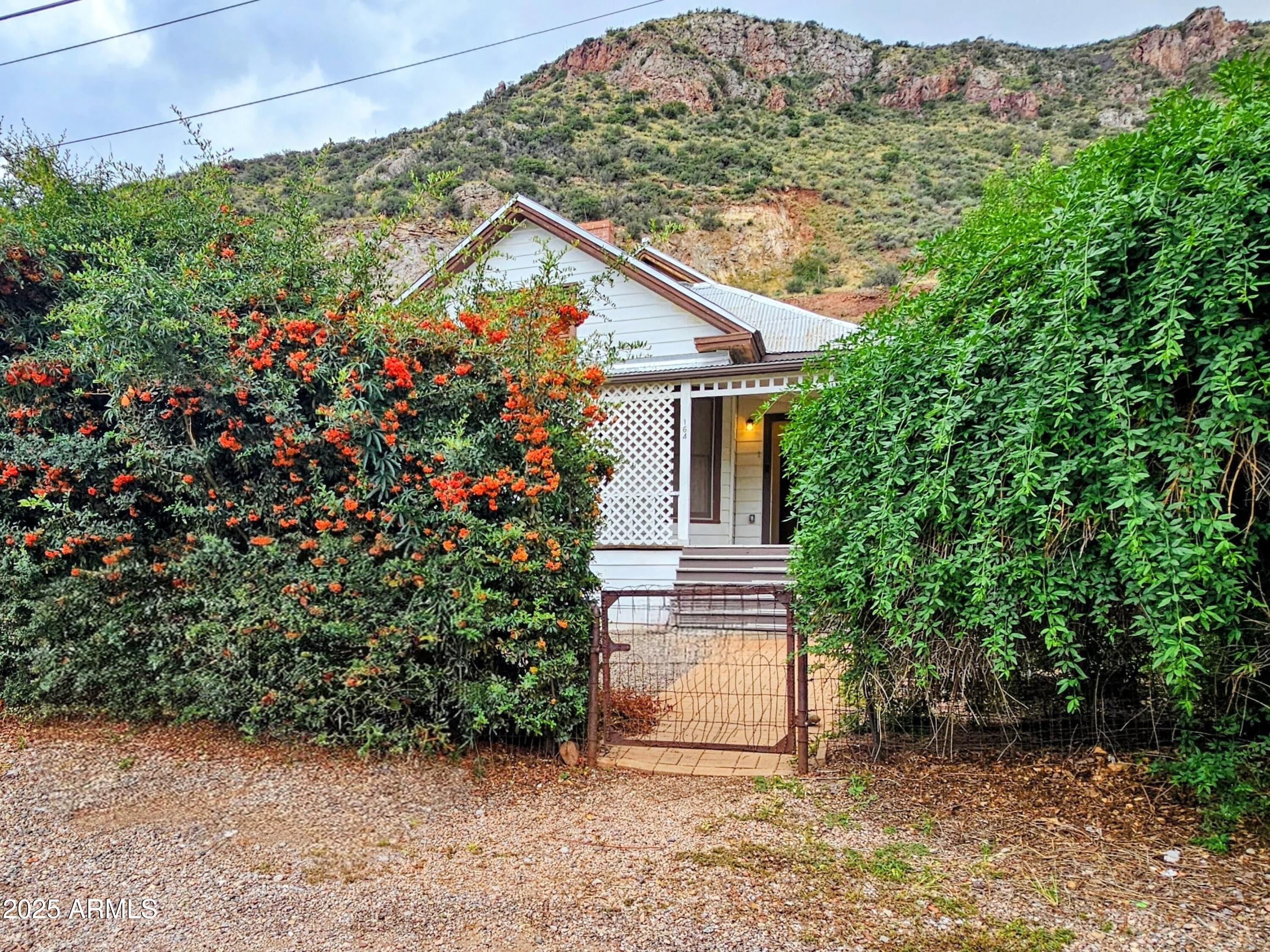 164 Quality Hill Road Bisbee, AZ 85603 - Photo 35 of 36 a view of a house with a yard and garage