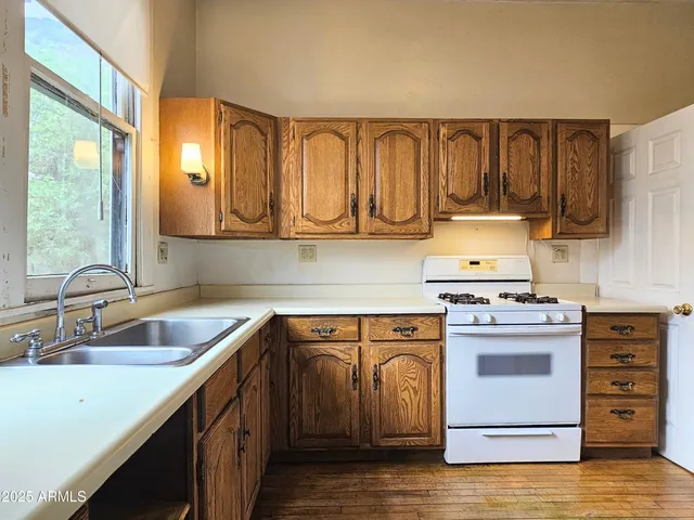 a kitchen with a stove top oven sink and cabinets