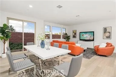 a view of a dining room with furniture window and wooden floor