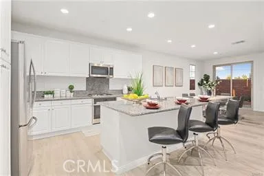 a kitchen with a stove and white cabinets