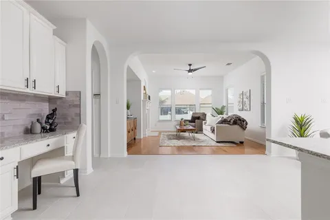 a view of living room with furniture and a potted plant