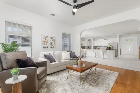 a living room with furniture and view of kitchen