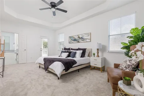 a spacious bedroom with a bed and a window