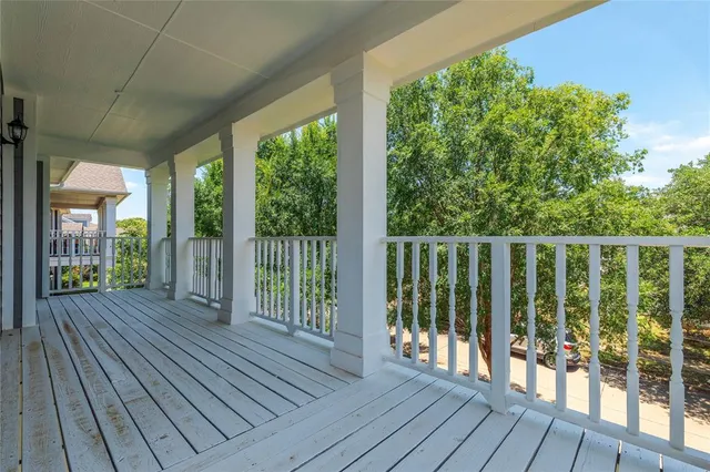 a view of backyard with a large window and wooden floor