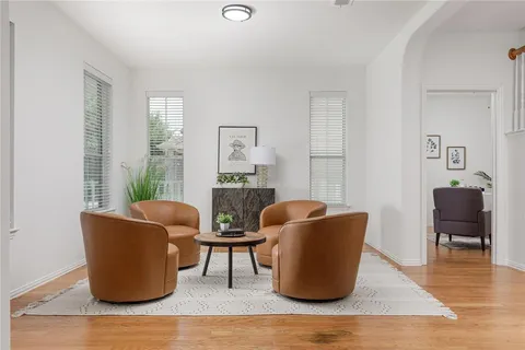 a living room with furniture and a wooden floor