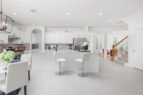 a living room with furniture and kitchen view