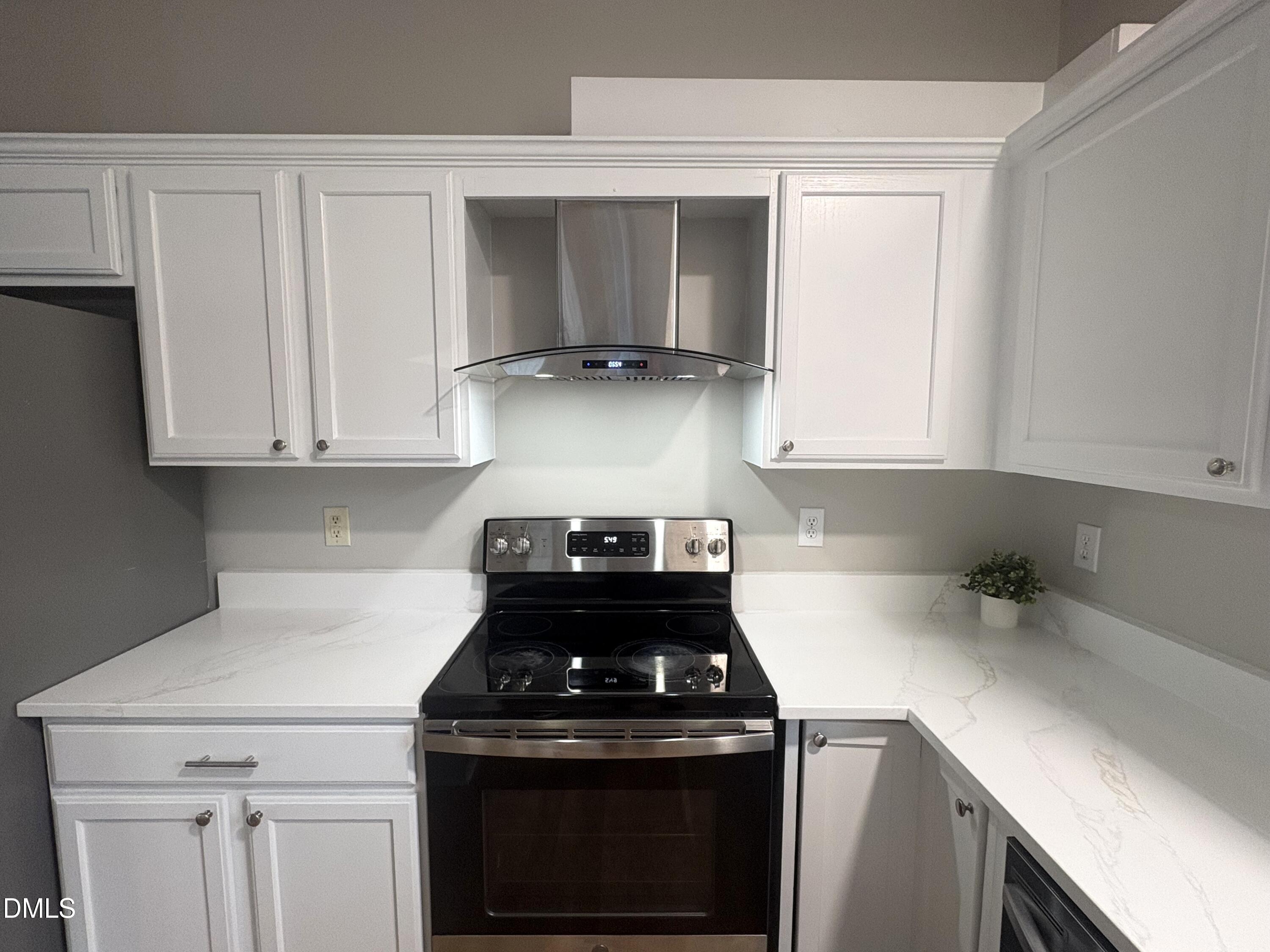 115 Chancellors Ridge Drive Durham, NC 27713 - Photo 7 of 57 a kitchen with granite countertop white cabinets and stainless steel appliances