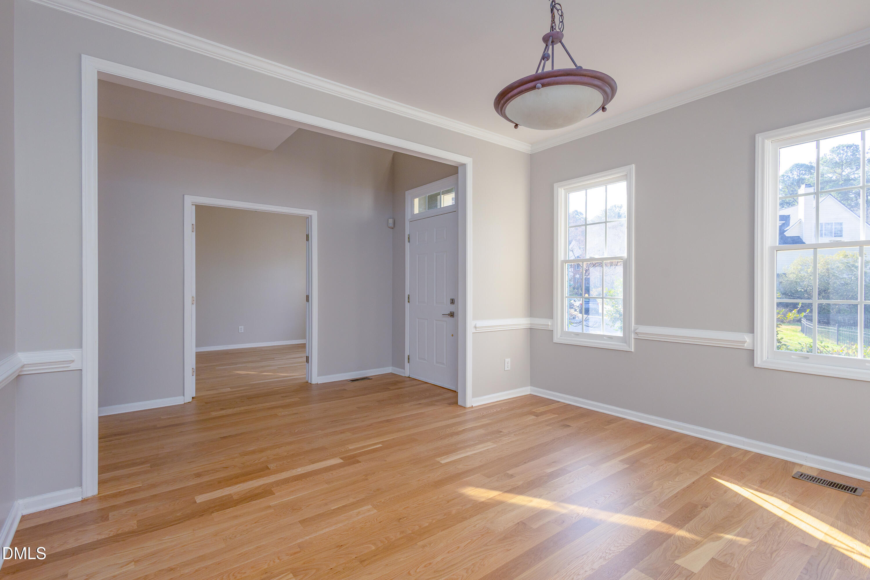 115 Chancellors Ridge Drive Durham, NC 27713 - Photo 13 of 57 a view of an empty room with wooden floor and a window