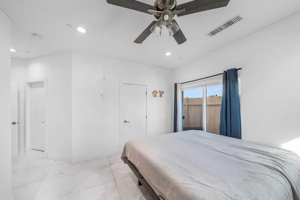 a bedroom with a large bed and a chandelier