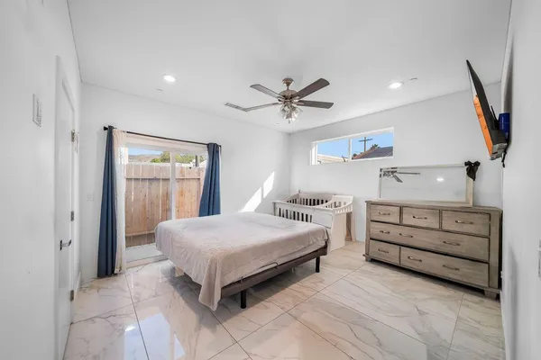 a bedroom with a bed and a chandelier