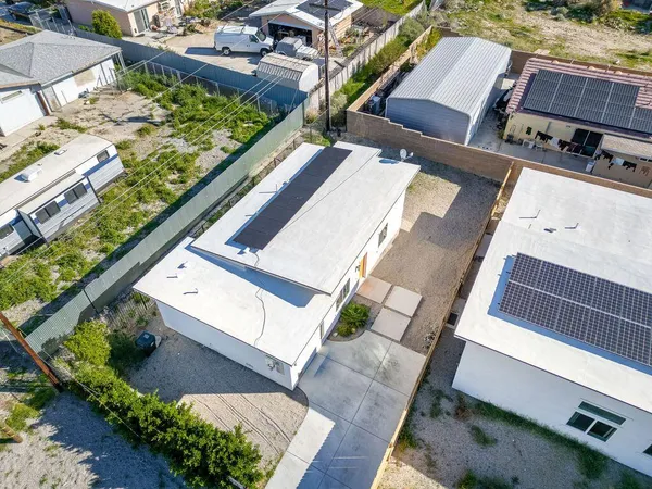an aerial view of a residential apartment building with a yard