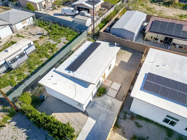 an aerial view of a residential apartment building with a yard