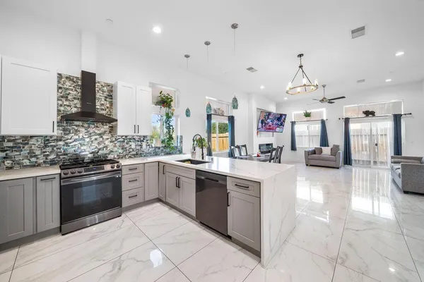 a kitchen with stainless steel appliances kitchen island granite countertop a sink and cabinets