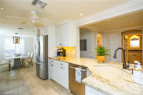 a kitchen with a sink refrigerator and microwave