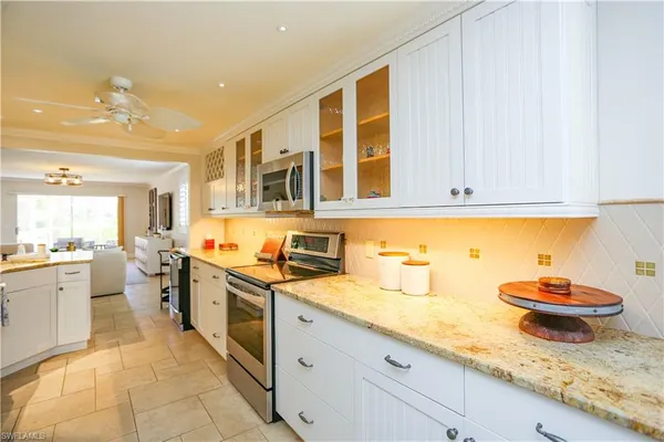 a kitchen with stainless steel appliances granite countertop a sink and cabinets