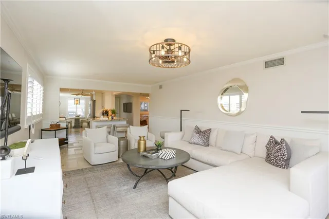 a living room with furniture and a large mirror