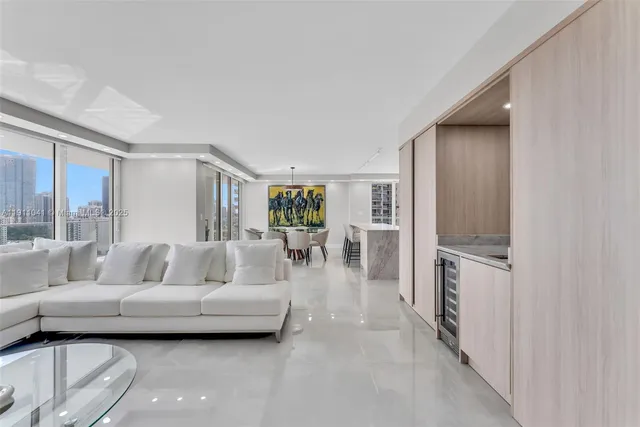a living room with furniture and a kitchen view
