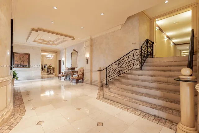a view of a hallway with wooden floor and cabinets