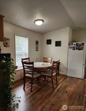 a view of a dining room with furniture and window