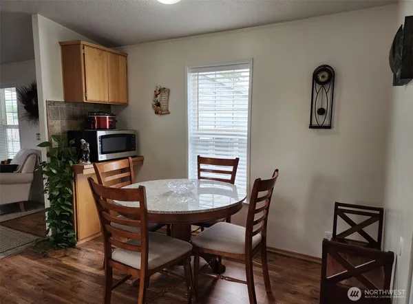a view of a dining room with furniture and wooden floor