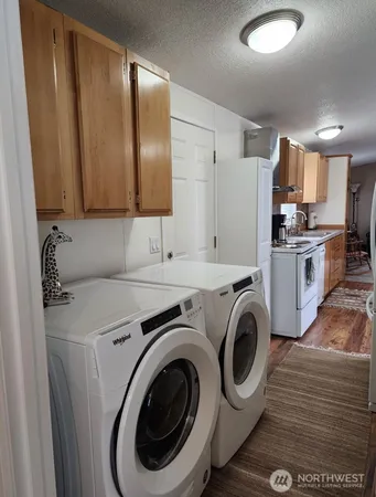 a view of a kitchen with washer and dryer